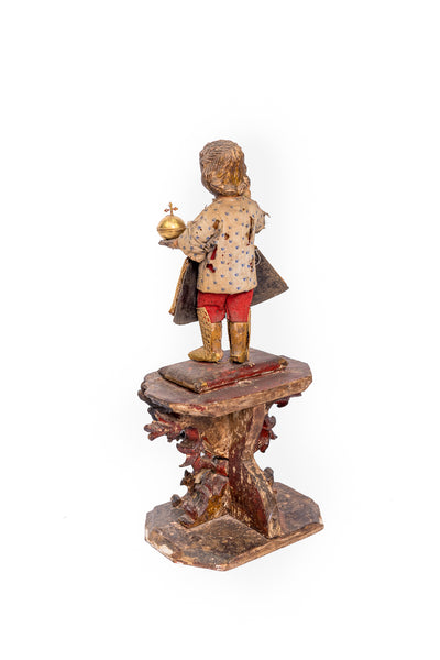 Santo Niño in wood with 22 karat gold gown, boots and host.