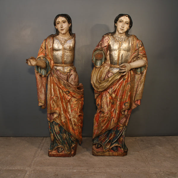 Pair of polychromed and silver leafed Archangels