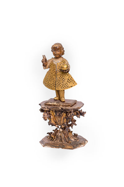 Santo Niño in wood with 22 karat gold gown, boots and host.